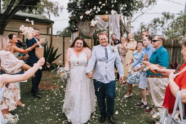 Confetti exit after a backyard wedding ceremony