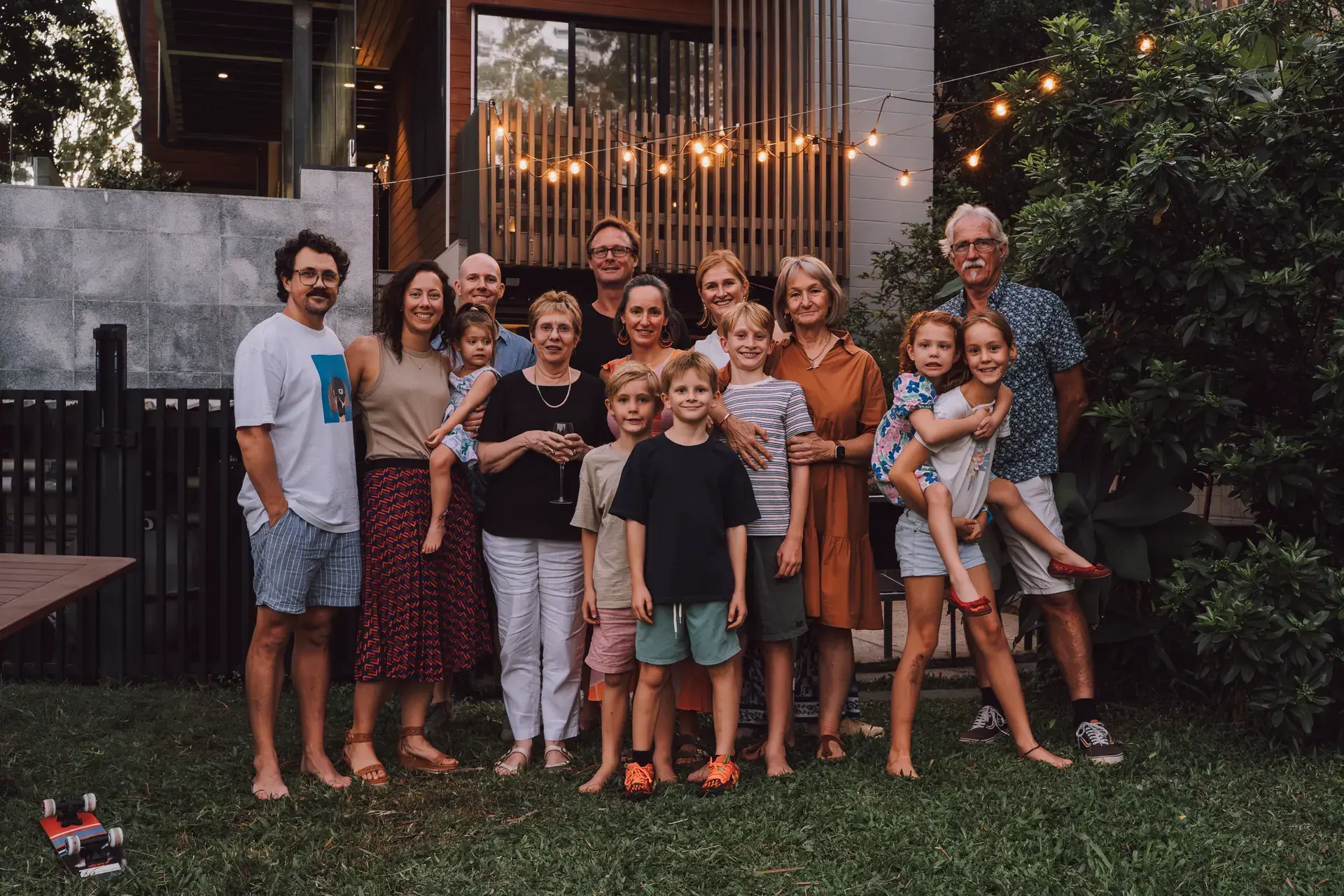 Extended family photographed together outdoors at dusk