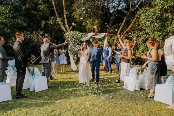 Petal toss down the aisle at a garden ceremony