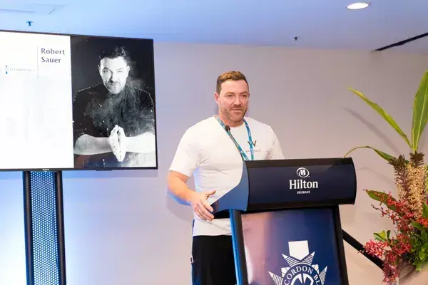 Speaker presenting at a Brisbane conference lectern